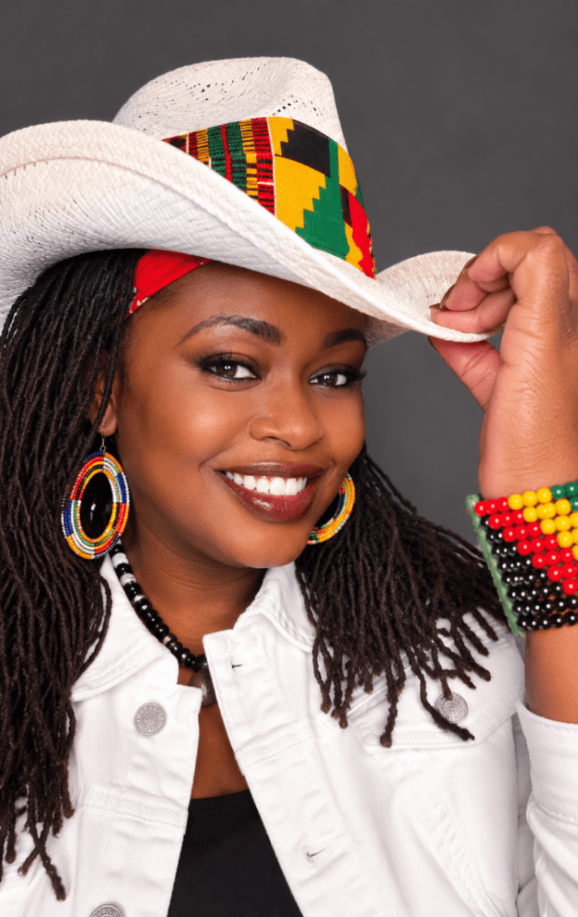 Anyumel Rose, comedian and performer, in a white cowboy hat with African beadwork